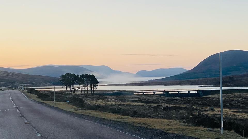 Scenic North Coast 500 road winding through the Scottish Highlands near Ullapool