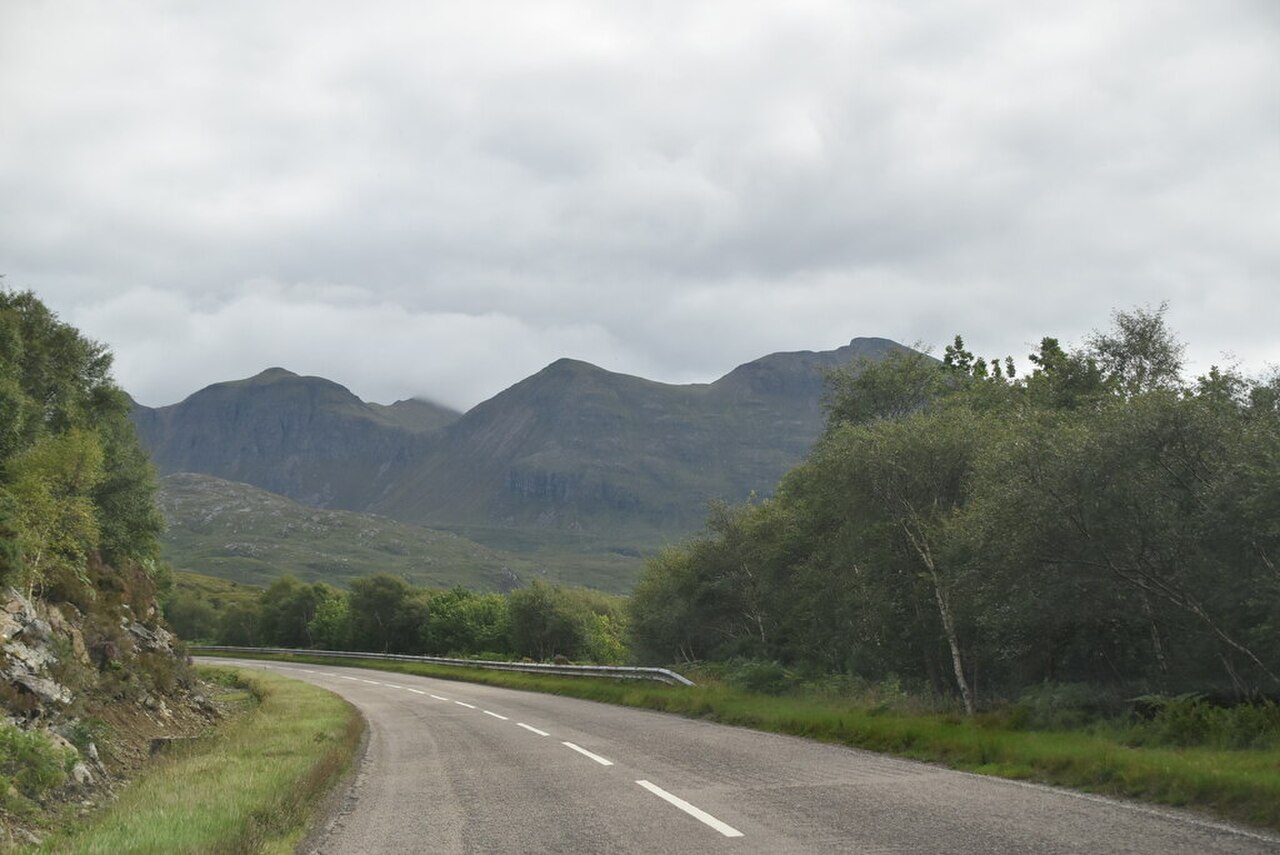 Scenic North Coast 500 road winding through the Scottish Highlands near Ullapool